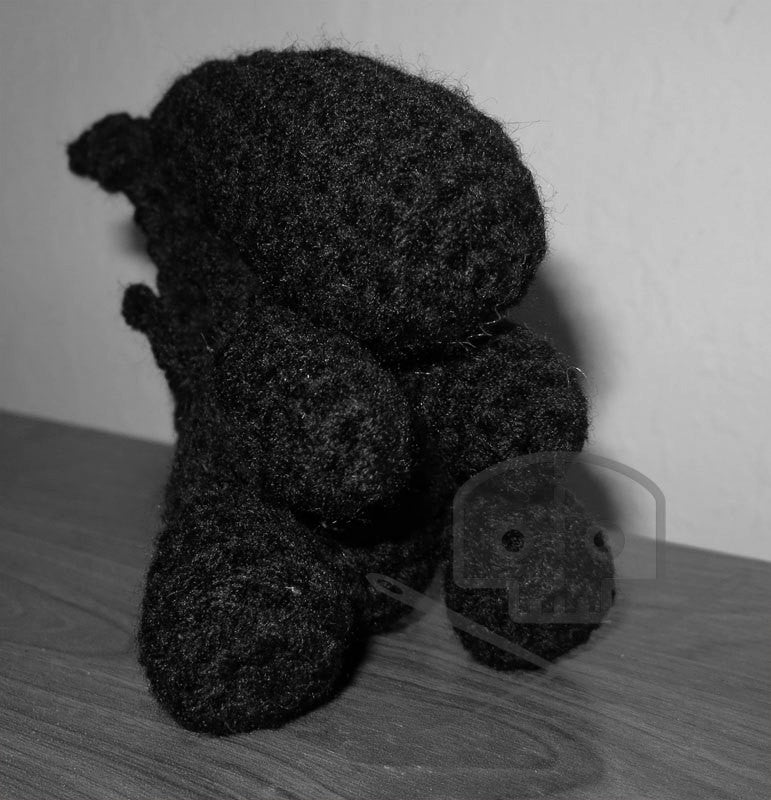 Monochrome image of an Alien-inspired crocheted Xenomorph plush toy